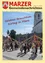 Eine Gruppe von Menschen tanzt um einen Maibaum vor einer Kirche mit einem Glockenturm. Der Textüberlagerung lautet 'Gefeiertes Brauchtum Kirtag im März'.