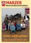 Eine Gruppe junger Kinder posiert für ein Foto vor einer Weihnachtskrippe. Die Kinder sitzen auf dem Boden, lächeln und scheinen sich in einem Klassenzimmer zu befinden.