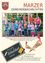 Eine Gruppe von Kindern und zwei Erwachsenen steht vor einem Spielplatz. Die Kinder tragen Freizeitkleidung. Das Bild trägt den Titel '1. Klasse der Volksschule Marz' und ist vom September 2010.