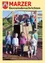 Eine Gruppe von Kindern mit Gesichtsbemalung posiert für ein Foto in einem Spielplatz mit einer Holzstruktur und einem roten Seilschwinger.
