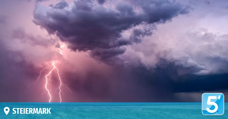 A dramatic sky filled with dark clouds and a striking bolt of lightning illuminating the scene.
