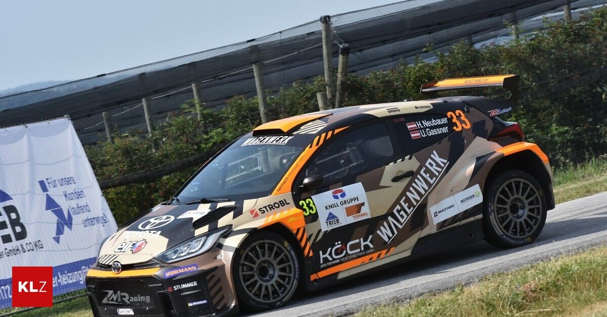 A Toyota GR Yaris rally car with a camouflage livery is driving on a race track. It has sponsors' logos and the number 33 on the side.