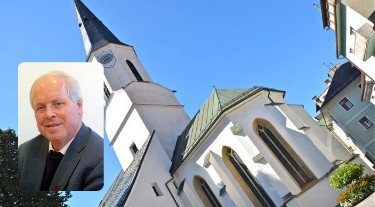 A white church with a steeple and clock, under a clear blue sky.