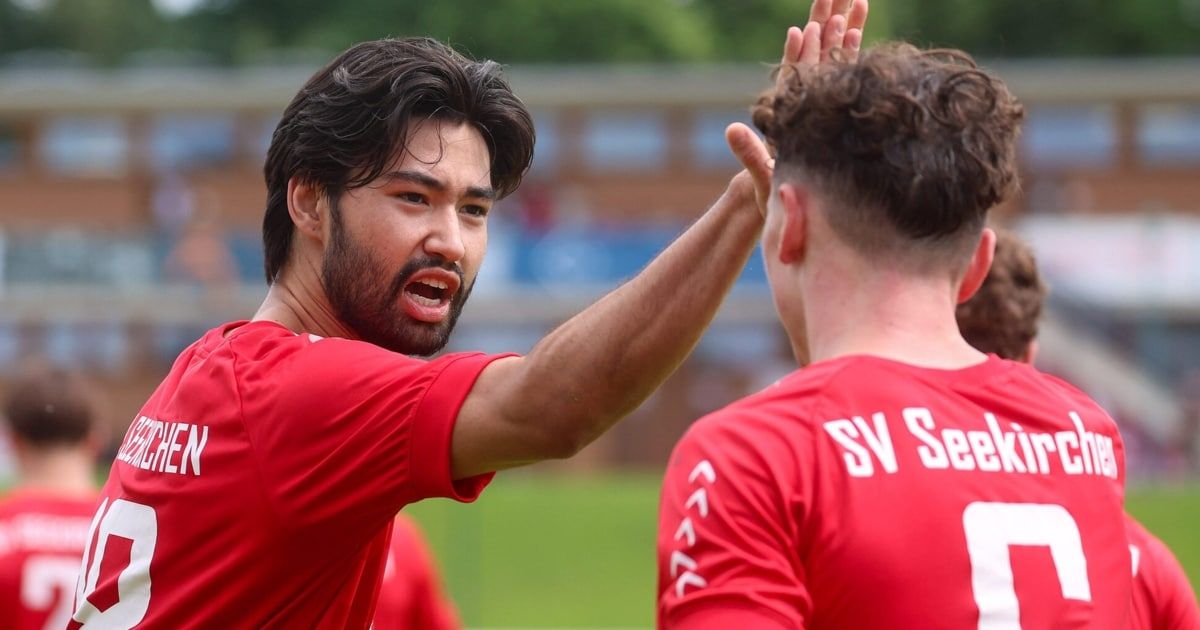 Two men in red jerseys, one with a beard, appear to be celebrating a soccer match.