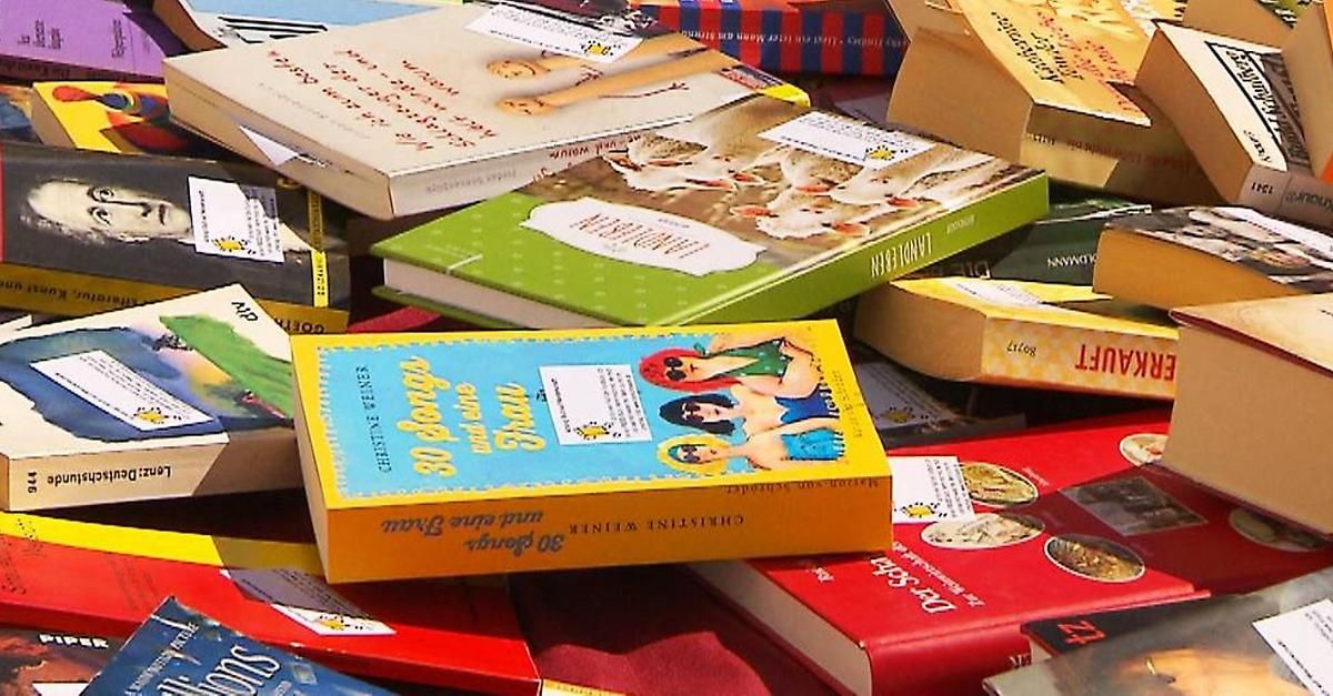 A pile of books on a table, including a yellow book titled '30 Days of Fun' with a cartoon character on the cover.
