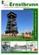 Ein Flugblatt für Ernstbrunn, das einen hohen Holzturm, eine Holzbank und eine Gruppe von Menschen vor einem Gebäude zeigt.