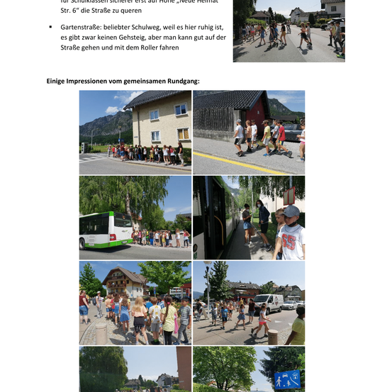 Das Bild zeigt mehrere Kinder, die zusammen auf einer ruhigen Straße gehen, wobei ein Kind einen Roller fährt. Die Straße heißt Neue Heimat.