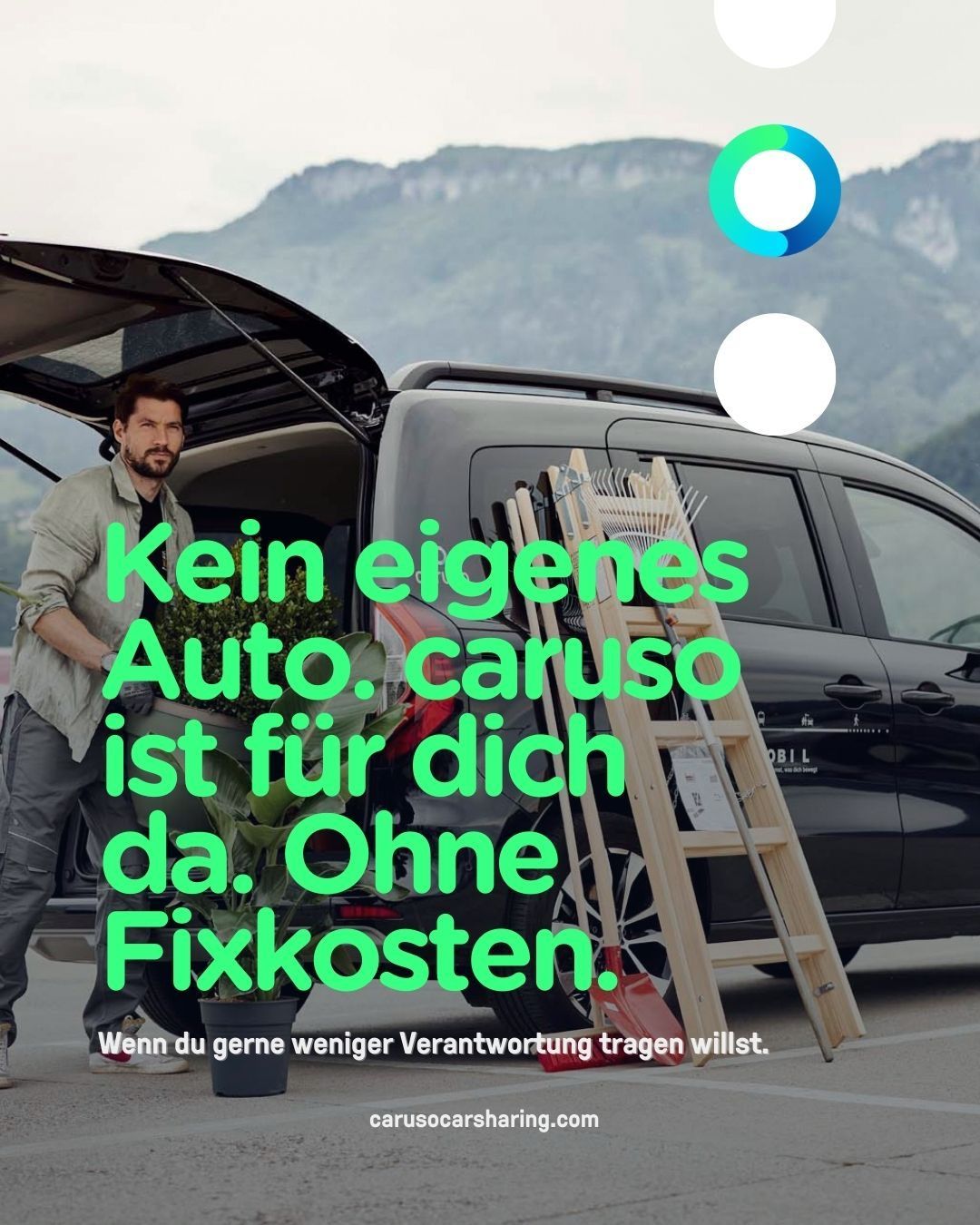 A man is standing beside a black car with the trunk open. He holds a plant in a pot. The car has text in German and a ladder leaning against it. In the background, there are mountains.