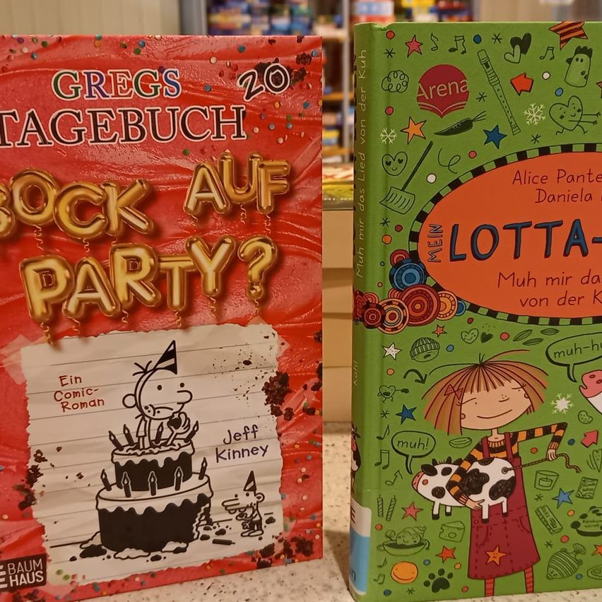 Two children's books side by side. On the left, a colorful book titled Greg's Diary 20: A Party? with a drawing of a cake and balloons. On the right, a book titled Lotta-Muh with a drawing of a girl and a cow.