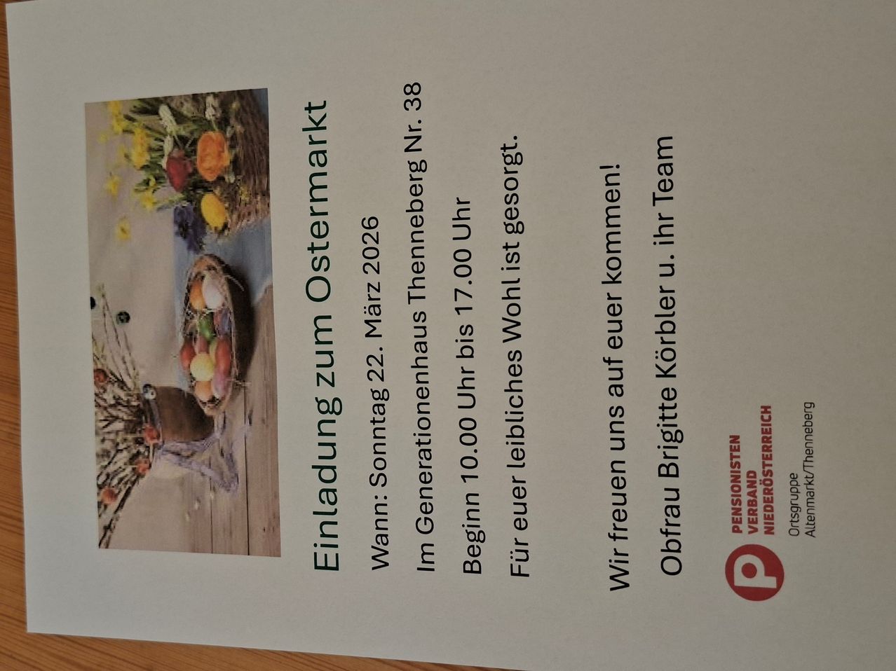Poster with an image of a basket of fruits. Text: 'Einladung zum Ostermarkt. Wann: Sonntag 22. Marz 2026. Beginn 10.00 Uhr. Im Generationenhaus Theneberg Nr. 38. For your favorite list sorted. We invite you to come. Frau Brigitte Körber u. ihr Team.'
