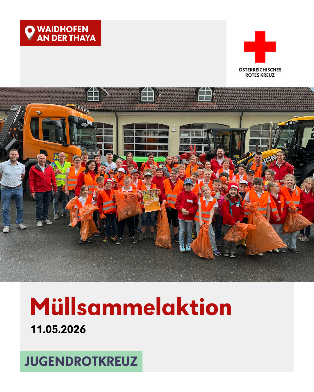 A group of people in orange vests and hats gather for a photo in front of a building. Date: 11.05.2026.
