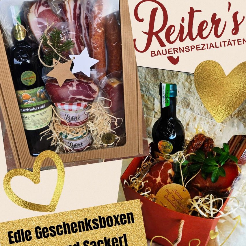 Two gift boxes filled with meat products and bottles, wrapped in festive decorations. One box has a label that reads Reiter's Bauernspezialitäten.