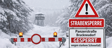 Snowy road with closed signs and warning triangles. The signs indicate a closed road due to heavy snow.