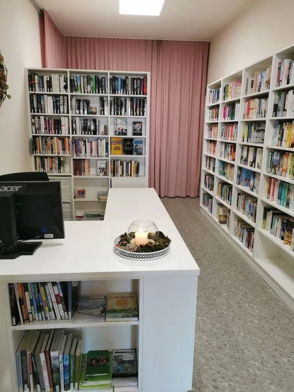 Furniture, Book, Indoors, Library, Publication, Bookcase, Table, Monitor, Building, Candle