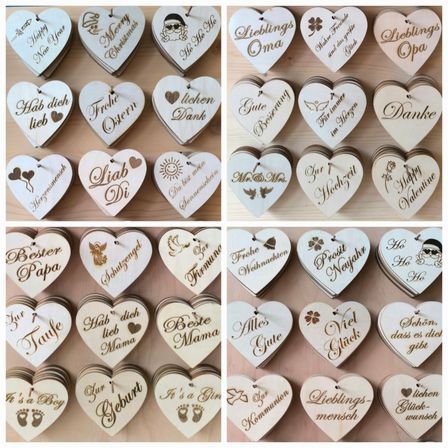 Eine Sammlung von Holzherzen mit verschiedenen Aufschriften, wie 'Frohe Weihnachten', 'Schönes Neues Jahr' und 'Lieblings Oma'. Jedes Herz ist mit unterschiedlichen Symbolen verziert und hat eine andere Farbe. Die Herzen sind in einer Collage mit einem hölzernen Hintergrund angeordnet.