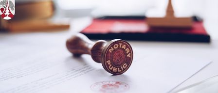 Ein hölzerner Notar-Siegel auf einem Dokument, beschriftet mit 'Notar Publicus', mit verschwommener Büroumgebung.
