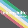 Ein bunt gestreiftes Logo mit weißem Text 'lebenshilfe' und 'Furstenfeld' auf grauem Hintergrund.