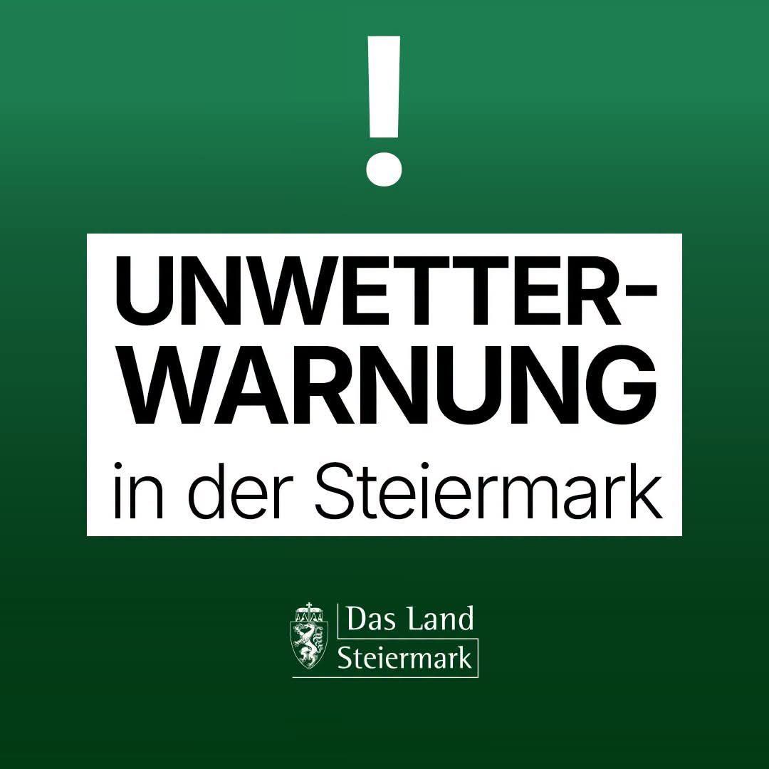 A white box with black text on a green background displays a weather warning for Styria. A red exclamation mark is above the text.