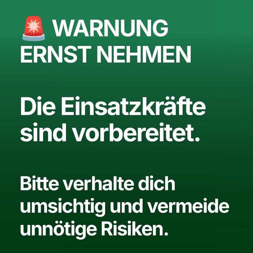 A green poster with a red emergency light icon and bold text reading 'WARNING SERIOUSLY TAKE'. Below, it says 'The emergency services are prepared. Please act carefully and avoid unnecessary risks.'