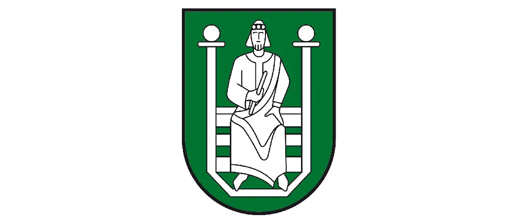 Ein Wappen in Grün, das eine sitzende Figur mit einem Buch und einem Bart darstellt, umgeben von weißen Linien.