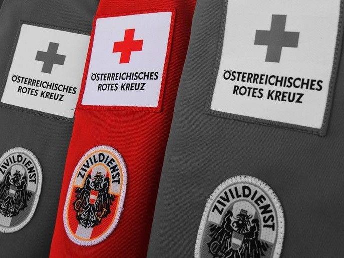 Three gray jackets with red patches and white patches. The patches have a red cross and the text reads Osterreichisches Rotes Kreuz.