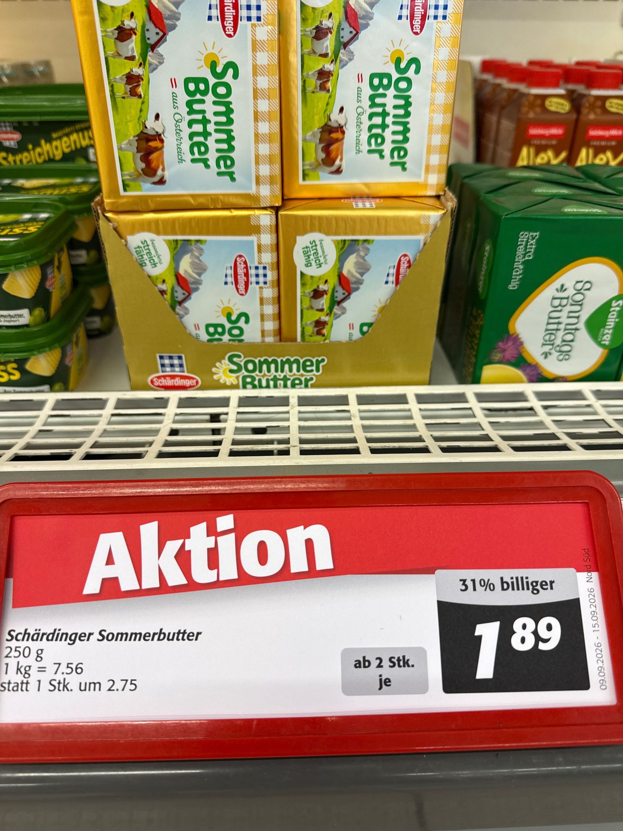A promotional sign for Schardinger Sommerbutter butter, showing a 31% discount, with a price of 1.89 euros for 250g. The original price is 2.75 euros per kilogram.