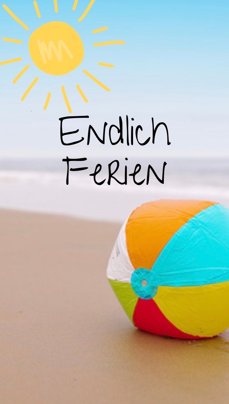 A colorful beach ball on a sandy beach with the words 'Endlich Ferien' written above it in German. The sun is shining brightly in the sky.