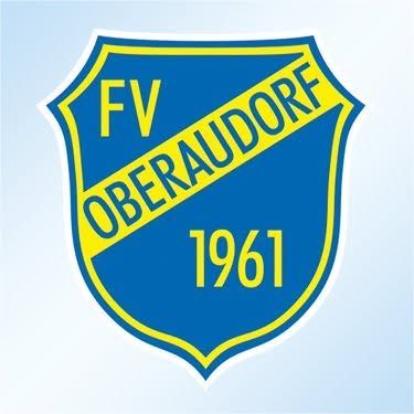 Das blau-gelbe Schild zeigt die Buchstaben 'FV' und den Namen 'OBERAUDORFE' mit dem Jahr '1961' darunter. Es hat einen gelben Rand und steht auf einem blauen Hintergrund.
