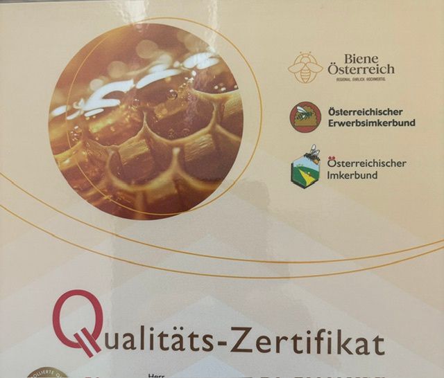 A quality certificate for beekeeping products from Austria, featuring a close-up of a honeycomb with water droplets and logos of beekeeping associations.