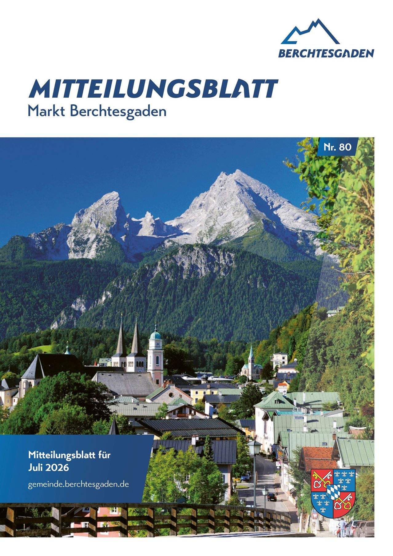 A scenic image of a mountainous region with a village below, featuring a clear blue sky, snow-capped mountains, and lush greenery. The village has traditional architecture with steep roofs and spires. The image is titled 'Mitteilungsblatt Markt Berchtesgaden Nr. 80'.