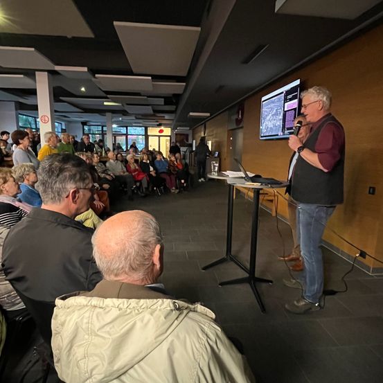 Bild enthält, People, Person, Furniture, Table, Desk, Adult, Male, Man, Wristwatch, Crowd