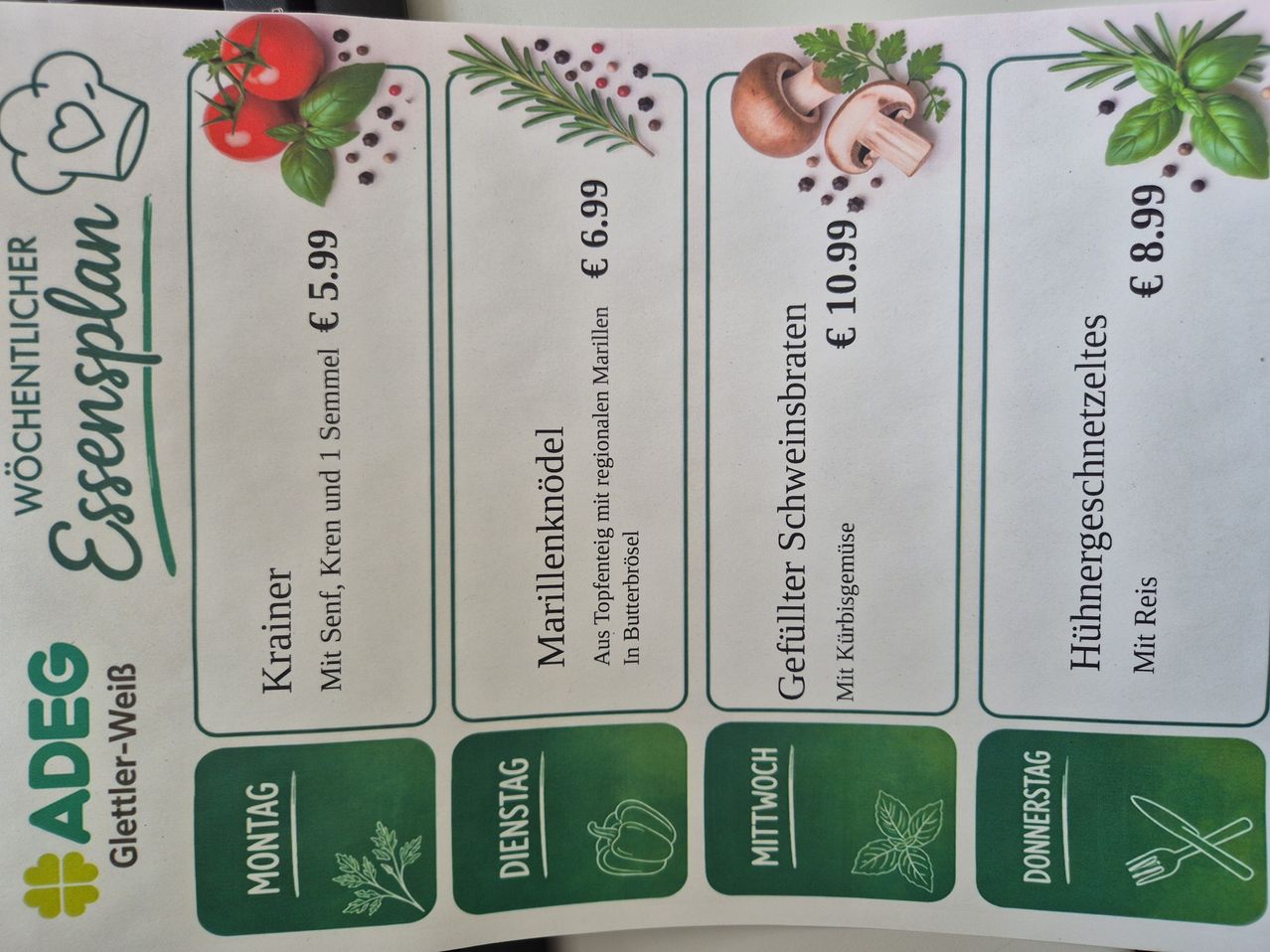 A menu with four items, each featuring a different vegetable or herb, priced in euros. The items are 'Krainer' with tomatoes and fennel, 'Marillenknödel' with apricots, 'Gefüllter Schweinsbraten' with pork, and 'Hühnergeschnetzeltes' with chicken.