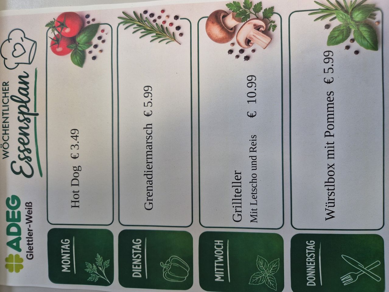 A menu board shows five options: Hot Dog priced at 3.49 euros, Grenadiermarsch at 5.99 euros, Grillteller at 10.99 euros, Wurstbox with pommes at 5.99 euros, and a picture of a pepper.