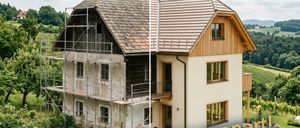 An image with two houses shows a renovation process. The left side is under scaffolding with the words 'Gut gedämmt'. The right side is finished with 'gut gespart'. There is a text overlay that reads 'New Funding: Thermal Insulation - Up to 30% Funding'.