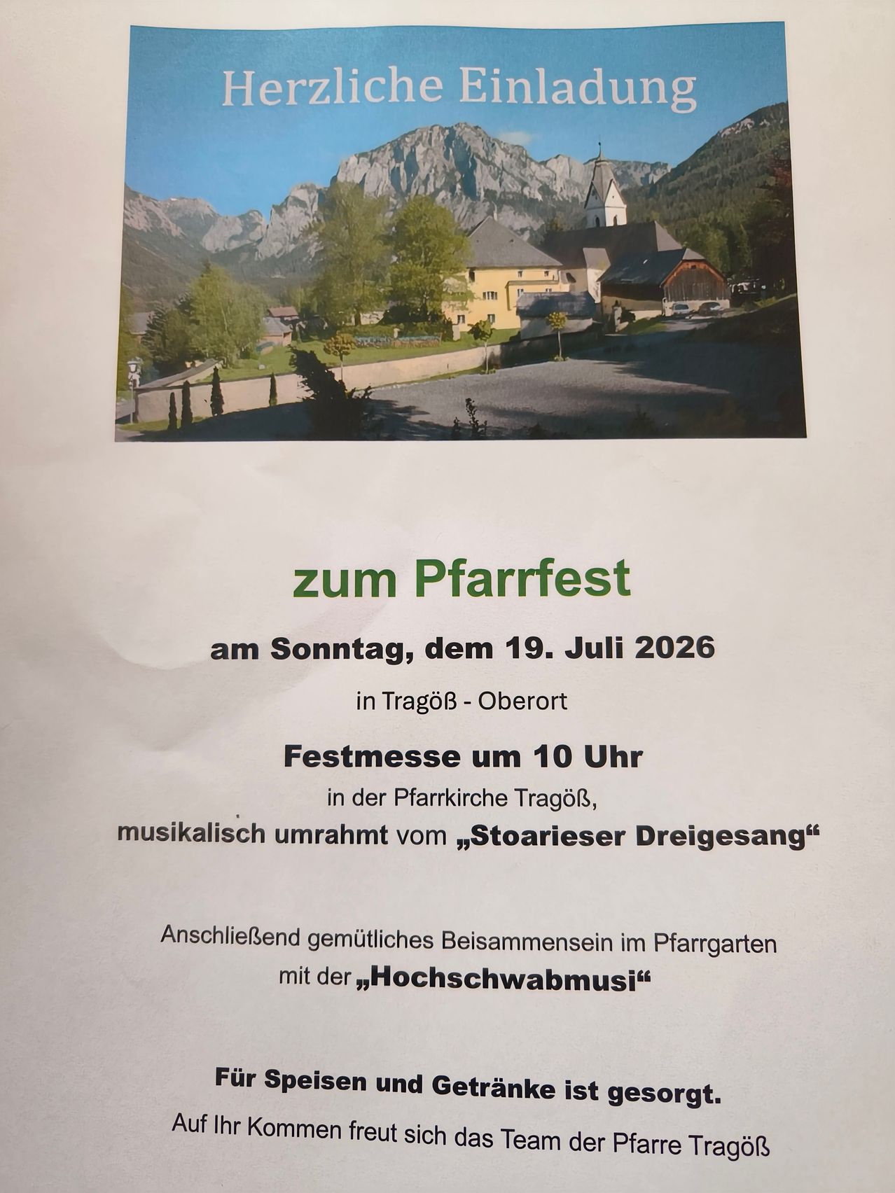 Poster for the Pfarrfest in Tragöß-Oberort on July 19, 2026, featuring a scenic mountain backdrop and a church. The event includes a festive mass at 10 AM and a gathering in the Pfarrgarten with music.