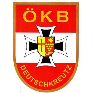 Das Emblem von OKB Deutschkreuz zeigt ein Kreuzsymbol mit rotem und weißem Hintergrund, gelbem Rand und einem kleinen Logo in der Mitte.