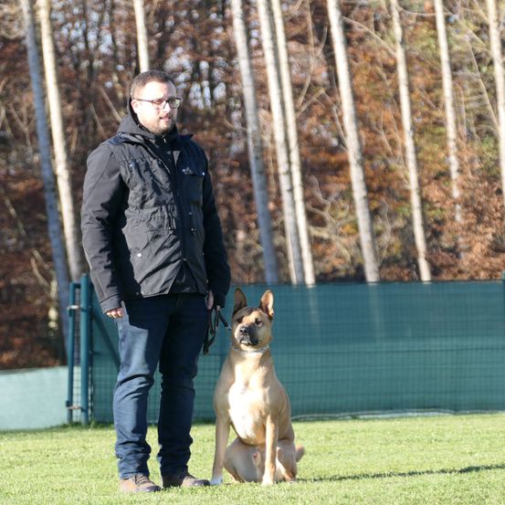 Bild enthält, Jacket, Pants, Adult, Male, Man, Person, Canine, Mammal, Dog, Pet