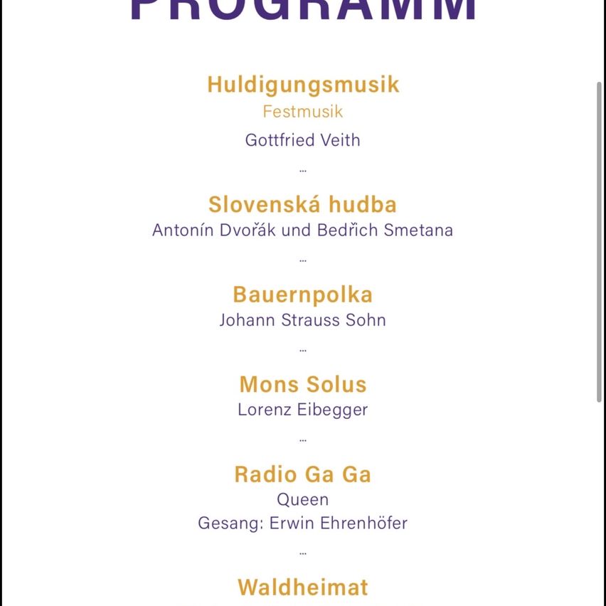 The program includes 'Huldigungsmusik' and 'Festmusik' by Gottfried Veith, 'Slovenska Hudba' by Antonin Dvorak and Bedrich Smetana, 'Bauernpolka' by Johann Strauss Sohn, 'Mons Solus' by Lorenz Eibegger, 'Radio Ga Ga' by Queen, and 'Waldheimat'.