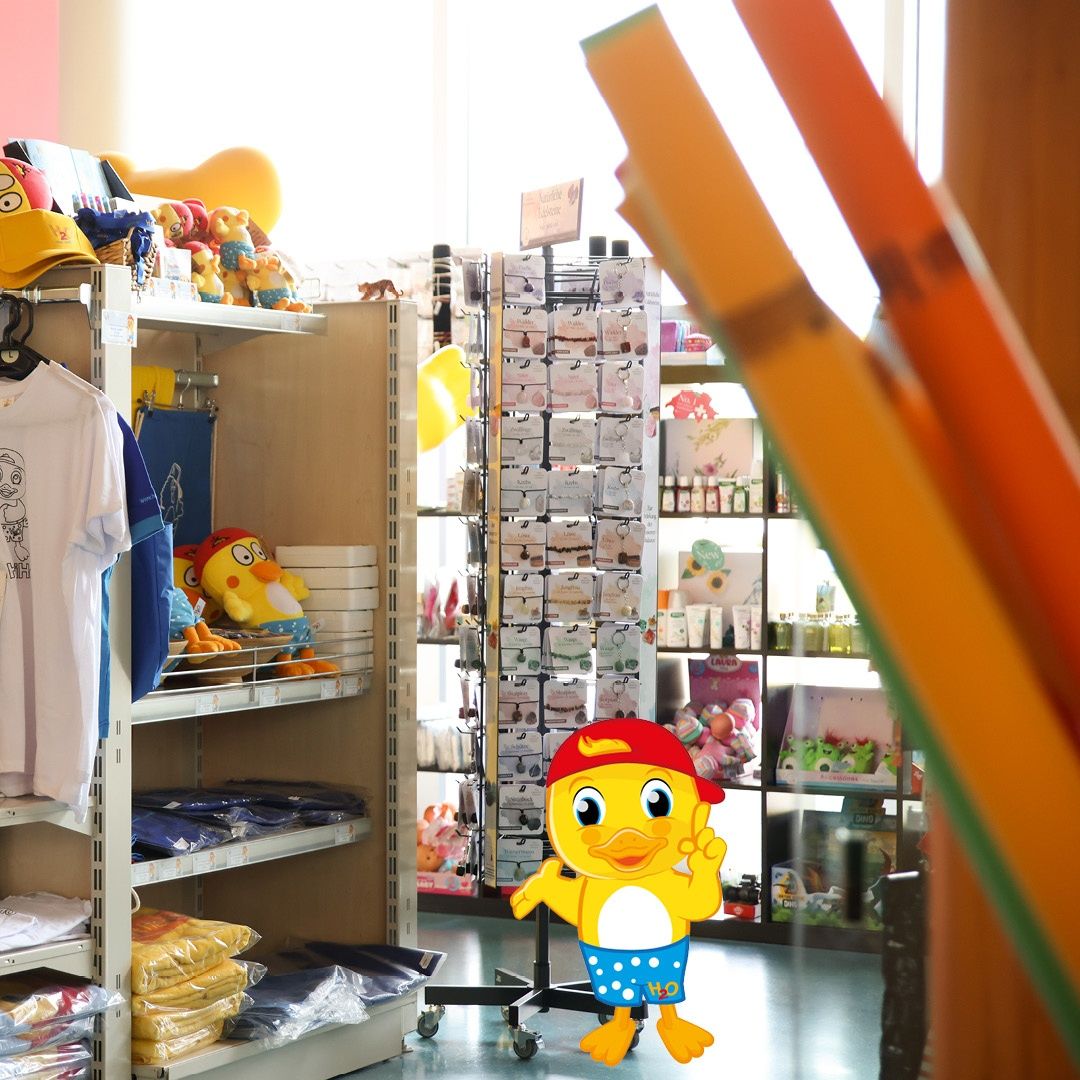 A store with shelves of various items including clothing and toys. A yellow cartoon character is prominently displayed.
