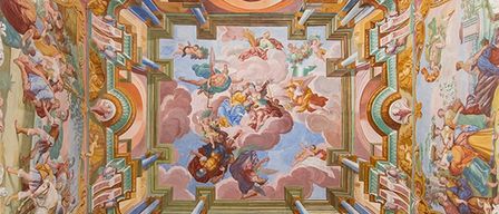 A grand ceiling adorned with intricate frescoes depicting mythological scenes, vibrant colors, and ornate details, creating a majestic and awe-inspiring atmosphere.
