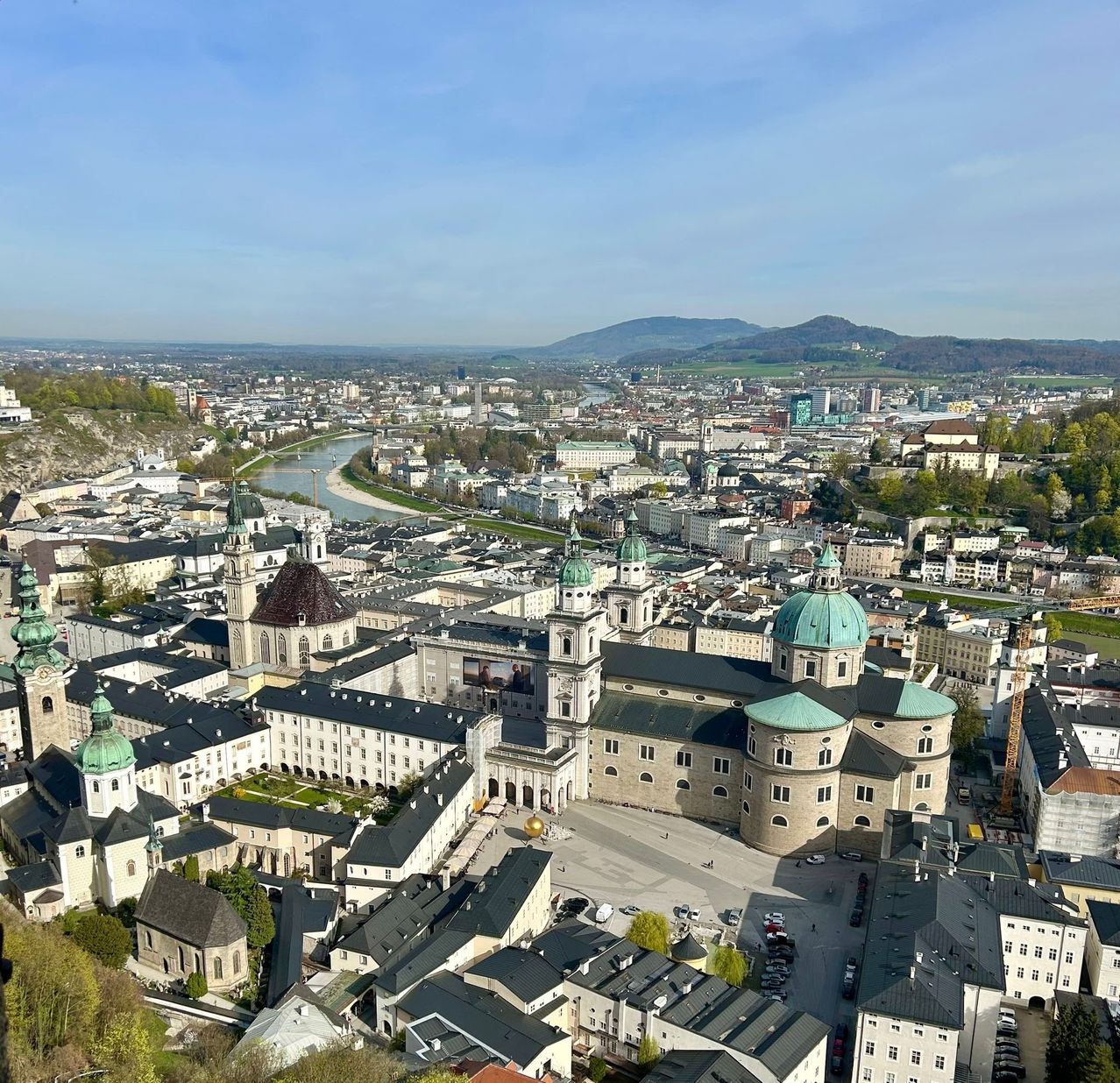 Aerial view of Salzburg, Austria, featuring the historic city center with its baroque architecture, the Salzach River, and the Hohensalzburg Fortress.