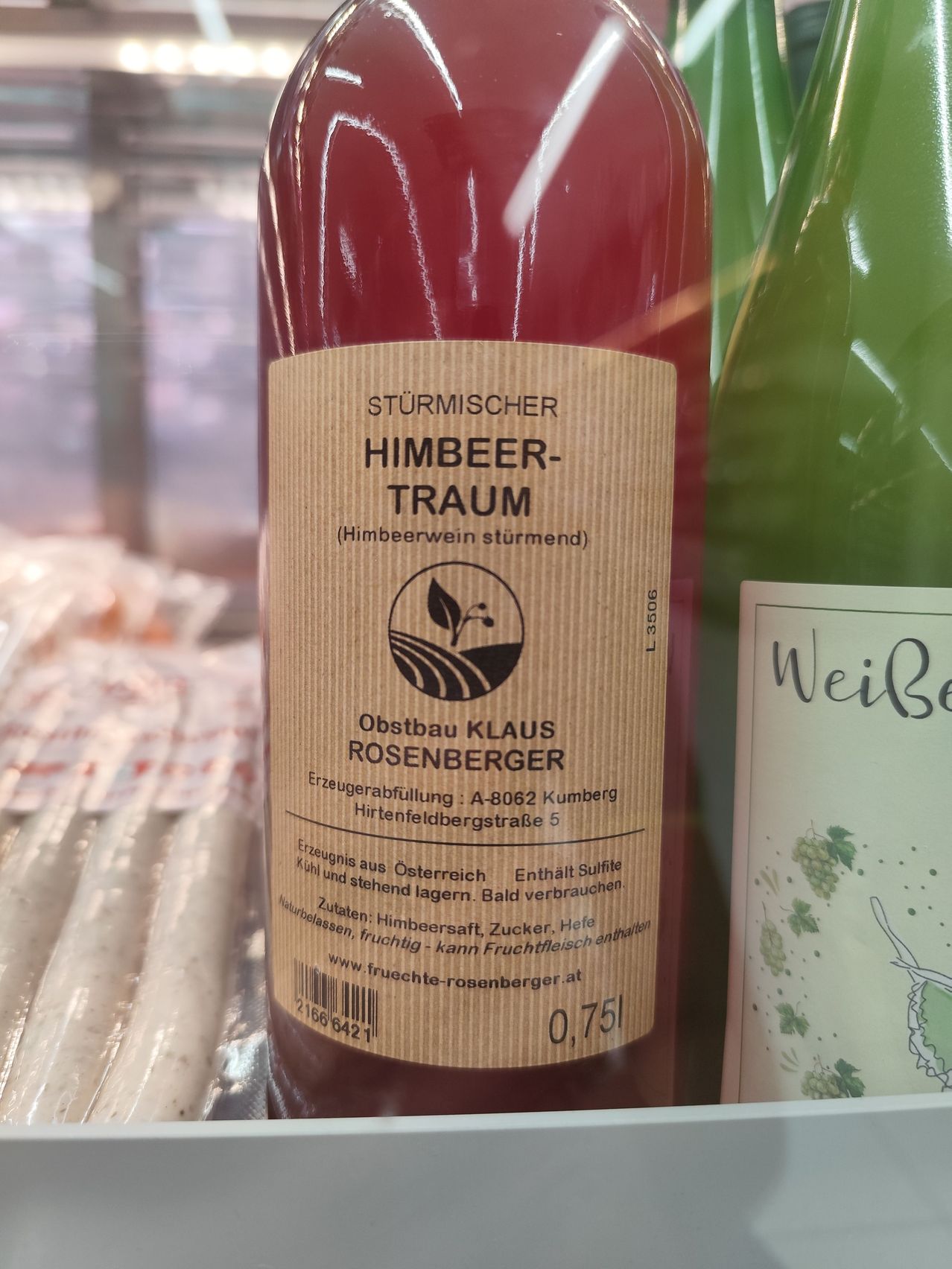 A bottle of Sturmischer Himbeer-Traum (strawberry wine) from Obstbau Klaus Rosenberger. The label includes details such as ingredients, production information, and a barcode.