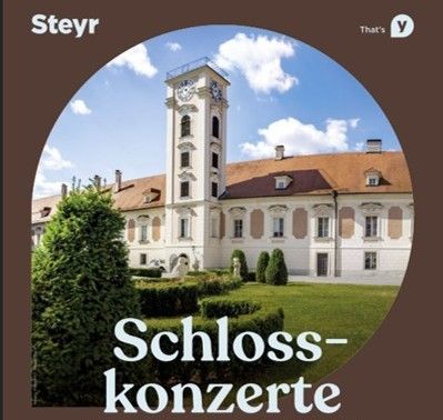 Ein kreisförmiges Bild zeigt ein klassisches Gebäude mit einem Glockenturm. Der Text 'Schloss-Konzerte' ist prominent angezeigt. Das Gebäude ist vor einem Hintergrund aus blauem Himmel und Grün.