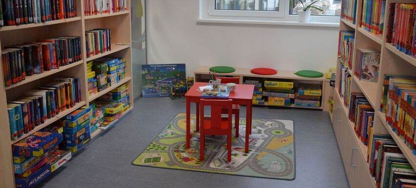 Bild enthält, Book, Indoors, Library, Publication, Furniture, Rug, Chair, Bookcase, Building