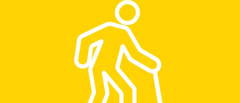 Eine einfache weiße Illustration einer Person, die mit einem Stock auf einem gelben Hintergrund geht.