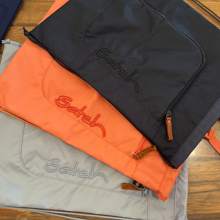 Three bags stacked on top of each other, each with the word Sateh in different colors and styles.