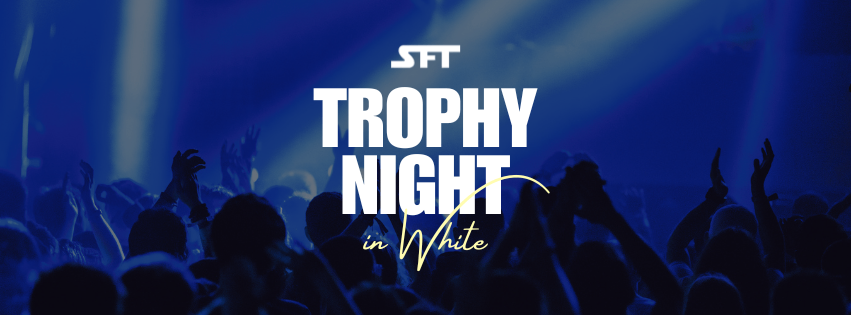 Eine Menschenmenge bei einem Konzert oder Event, die mit erhobenen Händen jubelt, unter blauem Bühnenlicht, mit dem Schriftzug Trophy Night in White prominent angezeigt.