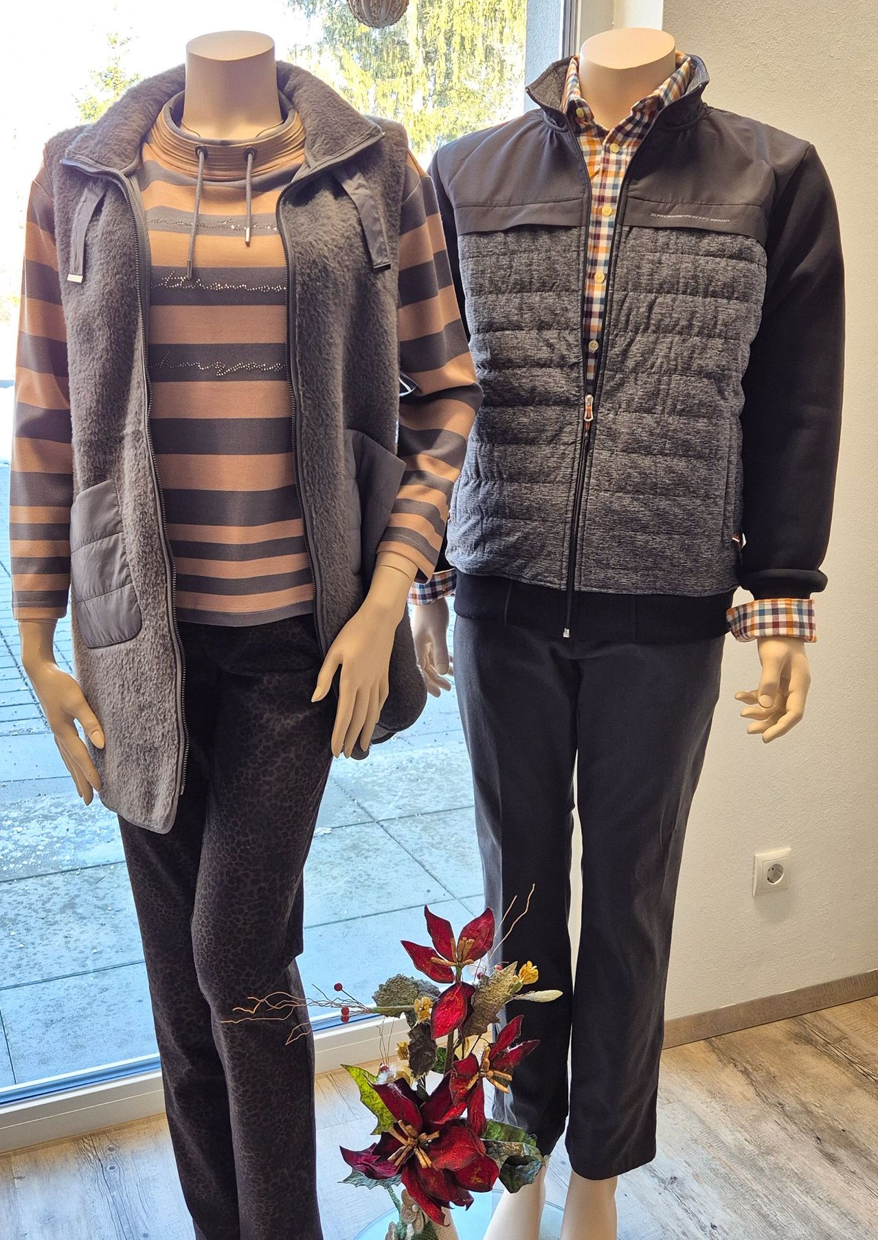 Zwei Mannequins sind in Herbstkleidung gekleidet, eines in einem gestreiften Shirt und das andere in einem karierten Shirt, beide tragen Hosen.