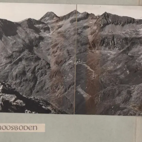 Eine Bergkette mit rauem Gelände und einem gewundenen Pfad im Tal unten, beschriftet mit '00SBoden'.