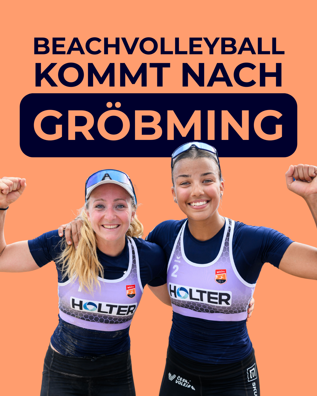 Zwei Frauen in Beachvolleyball-Trikots, eine mit der Nummer 2, posieren mit erhobenen Fäusten zur Feier. Im Hintergrund steht der Text 'Beachvolleyball kommt nach Gröbming'.